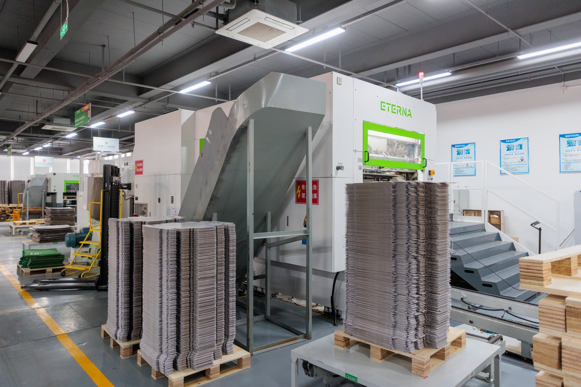 automated paper mounting equipment in packaging factory