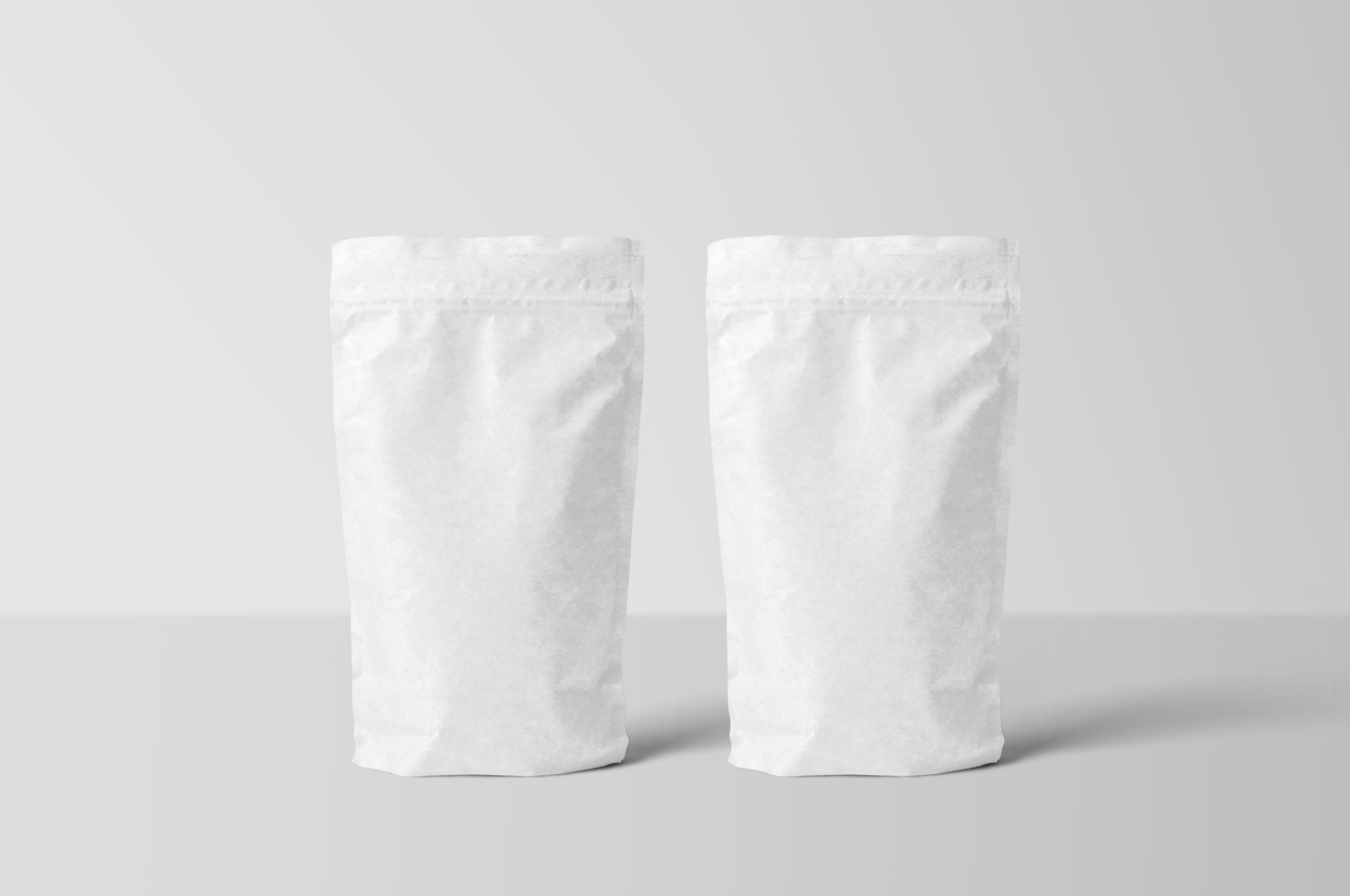 two white stand-up zipper pouches on a clean studio surface