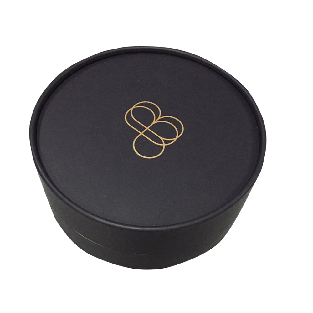 close-up of a black paper tube lid with a gold printed logo